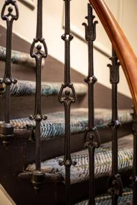 a set of three stairs with a metal railing at The Whisky Vaults in Oban +37 photos