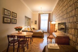 Scharffenberg Apartments Main Square في كراكوف: غرفة معيشة مع أريكة وطاولة في غرفة