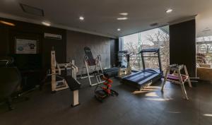 a gym with several tread machines in a room at Hotel Valentine Gyeongju in Gyeongju