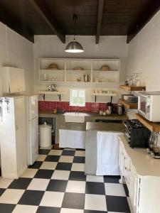 a kitchen with a black and white checkered floor at The Prime Spot Self Catering in Worcester