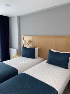 2 camas en una habitación de hotel con almohadas azules en Liberi Hotel Taksim, en Estambul