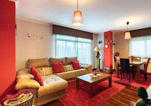 a living room with a couch and a table at Apartamento Plaza Perillana in Ponteareas