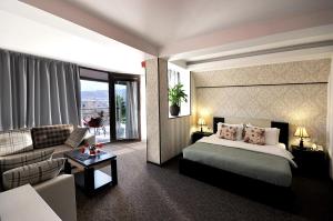 a hotel room with a bed and a couch at Light House Old City in Tbilisi City