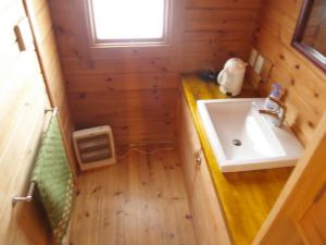 a small bathroom with a sink and a sink at Woody House Kazamidori in Myoko +50 photos