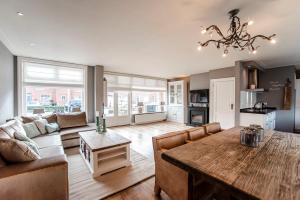 a living room with a wooden table and a couch at Guesthouse at the Beach in Zandvoort