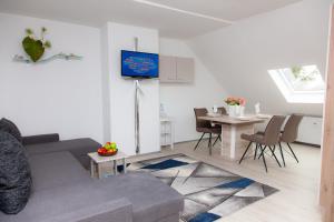 a living room with a couch and a table at T&K Apartments near Messe Fair Trade Düsseldorf und Airport 3A in Duisburg +6 photos