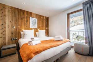 a bedroom with a large bed with towels on it at Le Globe Argentière Chamonix - by EMERALD STAY in Chamonix