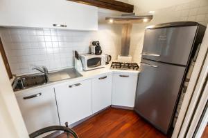 A kitchen or kitchenette at San Pantalon Luxury Penthouse R&R
