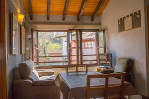 a living room with two couches and a table and a window at Los Picos in Porrúa
