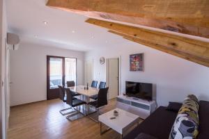a living room with a couch and a table with chairs at Vanja in Komiža
