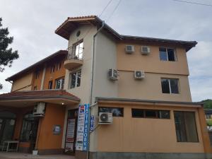 a building with a sign in front of it at Apartments Alexandra in Pleven