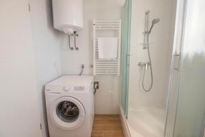 a small bathroom with a washing machine and a shower at Vanja in Komiža +52 photos