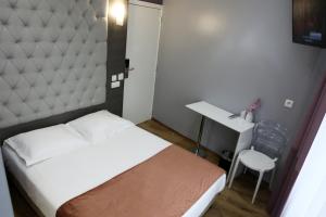 Vuode tai vuoteita majoituspaikassa Hotel Phenix