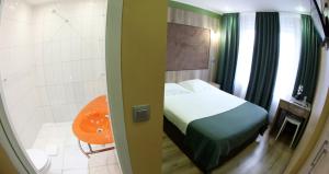 Vuode tai vuoteita majoituspaikassa Hotel Phenix