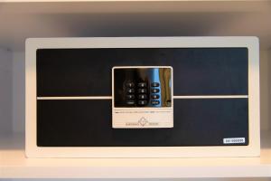 a microwave with a cell phone inside of it at Amplidi Hotel Hannover in Hannover