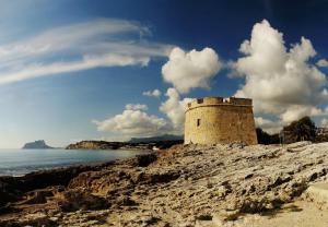 a building on a hill next to the ocean at La Sort Boutique Hotel in Moraira