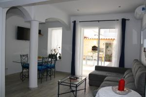 een woonkamer met een bank en een tafel bij House of Orchids with Pátio in Vila Real de Santo António