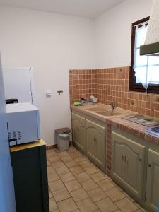a kitchen with a sink and a counter top at Résidence Lou Cigaloun - ANA LOCATION in Gréoux-les-Bains
