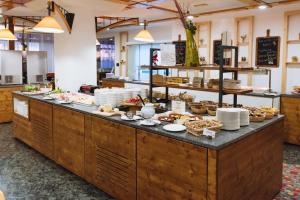 a buffet line in a restaurant with food at Bungalows Rogla in Zreče