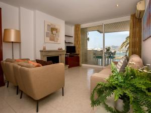 a living room with a couch and a fireplace at 'can ventet' first line beach in Port de Pollensa