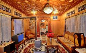 a living room with a couch and a tv at Golden Crest DALLAKE in Srinagar