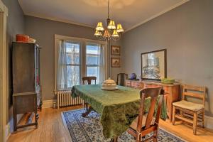 a dining room with a green table and chairs at Historic House with Record Player, Walk to Downtown! in Roxbury