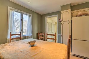 a kitchen with a table and a white refrigerator at Historic House with Record Player, Walk to Downtown! in Roxbury