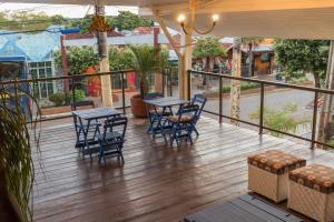 a patio with tables and chairs on a deck at VOA Hotel Paraíso das Águas Bonito in Bonito