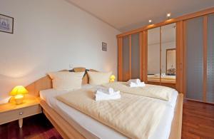 a bedroom with a bed with two towels on it at Villa Seegarten in Boltenhagen