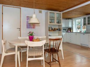 a kitchen and dining room with a table and chairs at 6 person holiday home in Glesborg in Glesborg