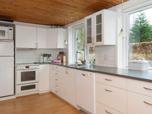 a kitchen with white cabinets and a counter top at 6 person holiday home in Glesborg in Glesborg