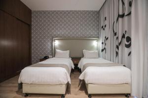 Voodi või voodid majutusasutuse La Locanda Boutique Hotel toas
