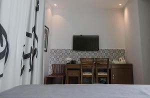 a room with a tv and a bed in it at La Locanda Boutique Hotel in Amman