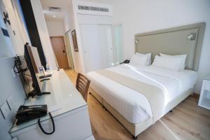 Voodi või voodid majutusasutuse La Locanda Boutique Hotel toas