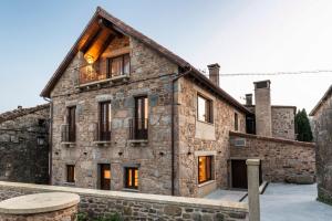 an old stone house with a balcony on it at Casa Néboa. in Negreira