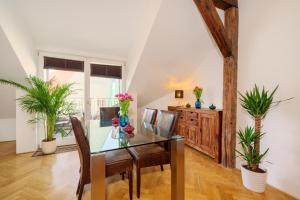 a dining room with a glass table and chairs at Old Town Square Premium Residence in Prague