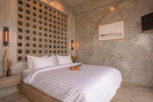 a bedroom with a large white bed with a tray on it at De' Anchor in Ko Si Chang