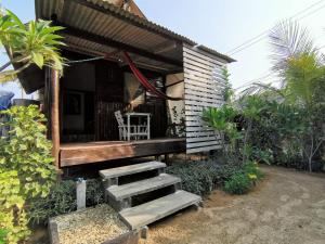 a small house with stairs leading to a porch at Sleep Whale Lanta in Ko Lanta