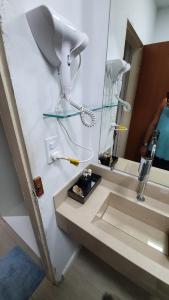 a bathroom with a sink and a mirror at #01 Boulevard Amazon Suites in Manaus +13 photos