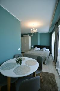 エゲルにあるUnicorniselit Apartmanokのベッドルーム1室(ベッド1台、テーブル、椅子付)