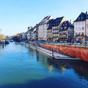 a river in a city with buildings and houses at A L'ill - Apparts & Studios Strasbourg Hyper Centre in Strasbourg