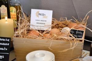 a basket filled with eggs and a candle at Be Place in Trento