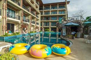 a swimming pool at a hotel with a resort at Ananta Burin Resort - SHA Extra Plus in Ao Nang Beach