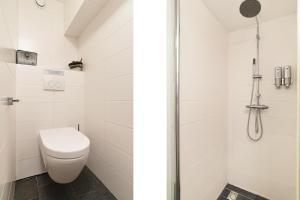 a bathroom with a toilet and a shower at Only Friends in Amsterdam +20 photos