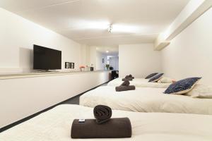 a bedroom with two beds and a flat screen tv at Only Friends in Amsterdam