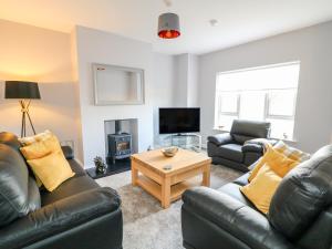 a living room with two couches and a tv at Culmore Point in Culmore