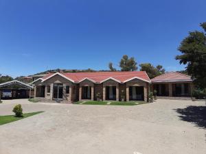 a brick house with a red roof at Citystay Ladybrand in Ladybrand