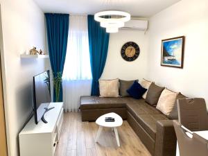 a living room with a couch and a table at Apartmani Kažanegra33 in Pržno