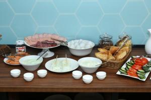 a table topped with bowls and plates of food at MANDARIN Hotel in Yerevan