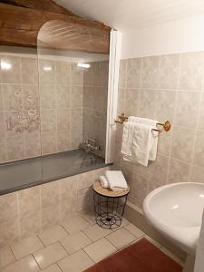 a bathroom with a shower and a sink and a tub at Logis Des Bessons in Migron